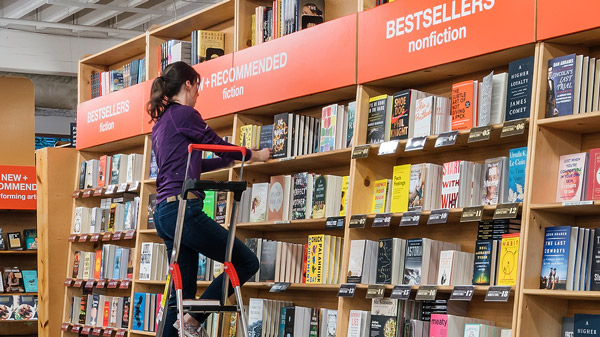 Powell's Books employee stocking shelves